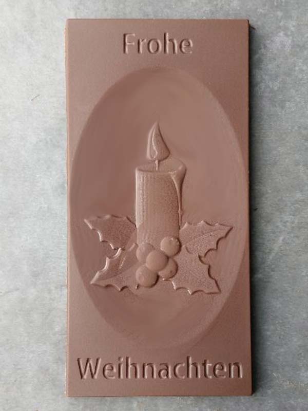 Chocolate bar "Frohe Weihnachten" with candle